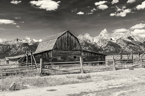Iconic John Moulton homestead with the Wyoming Tetons serving as a dramatic backdrop