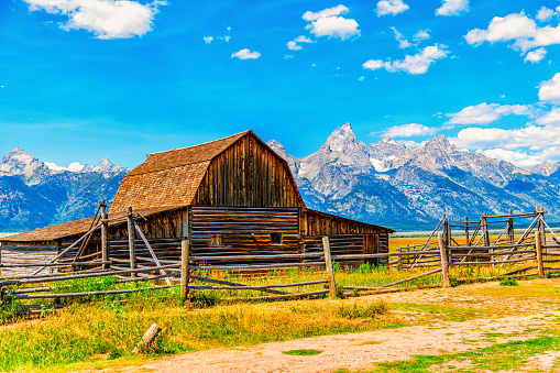 The Moulton Barn, a publicly owned national landmark along the Mormon Row Historic District in Grand Teton National Park, Wyoming with the peaks of the Teton Range in the background.  This barn, the John Moulton Barn is commonly dubbed the worlds second most photographed barn next to the T.A. Moulton Barn located just down the street.  Either way, the barns on Mormon Row are the most photographed in the world.