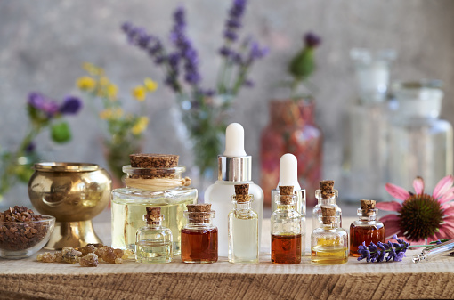 Selection nof aromatherapy essential oils with frankincense, myrrh, lavender, echinacea and other flowers