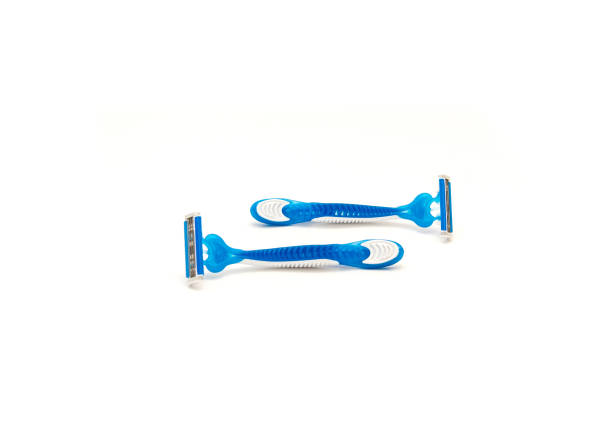 istock Two brand new blue and white plastic disposable razors with ergonomic handle isolated on white background 1426688023