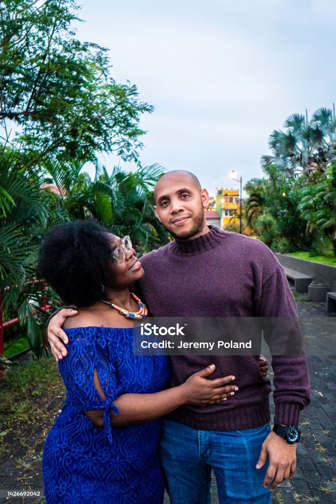 Cute Portrait of an Afro-Descendant Married Male and Female Couple Standing Together at Plaza V Centenario in Panama City, Panama Cute Portrait of an Afro-Descendant Married Male and Female Couple Standing Together and Smiling at Plaza V Centenario in Panama City, Panama 35-39 Years Stock Photo