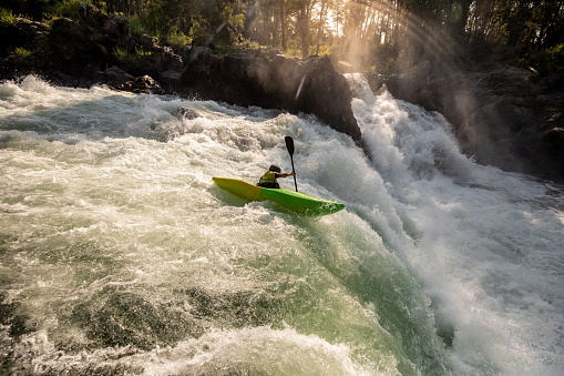 A kayaker getting ready to go down a waterfall in the Liucura river, Pucon, Chile