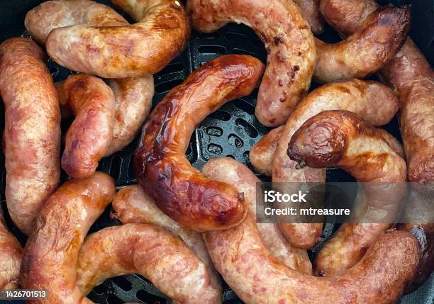 Full Frame Image Of Browning Pork Sausages Cooked In Air Fryer Healthier Alternative To Frying Pan Cooking Elevated View Stock Photo - Download Image Now