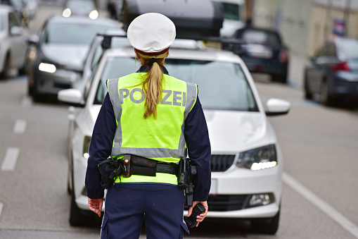 Policewoman on a street in Linz from behind