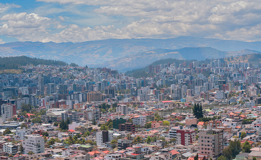 Panoramic view of the north central part of the city of Quito full of modern buildings with the Cumbaya valley in the background during a sunny morning