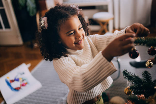 istock Girl Decorating A Christmas Tree 1426708847