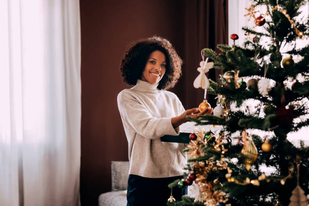 istock Woman Decorating Christmas Tree 1426708903