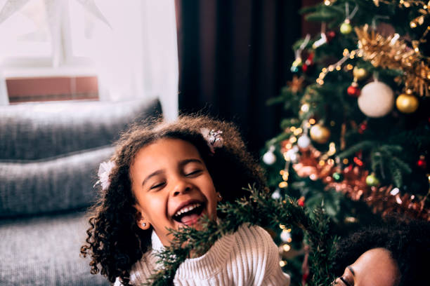 istock Girl Playing With Christmas Ornaments 1426708941