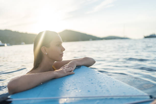 istock Young woman relaxes on SUP board on sea 1426710285