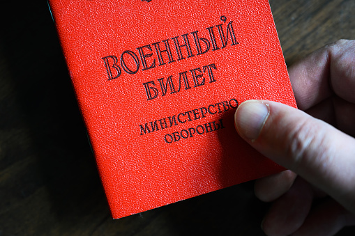 Certificate of Russian serviceman in hand, top view