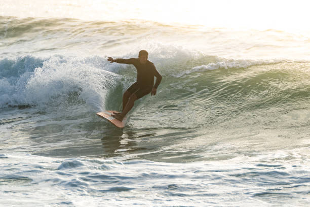 istock Surfer in action at sunset 1426711515