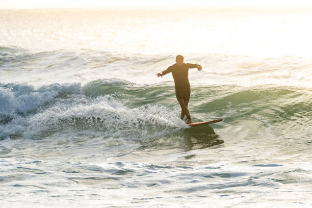 istock Surfer in action at sunset 1426711526