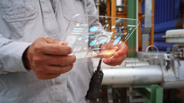 istock Engineers are inspecting manufacturing processes, reading holographic screens showing various piping and control systems within the plant. 1426712110