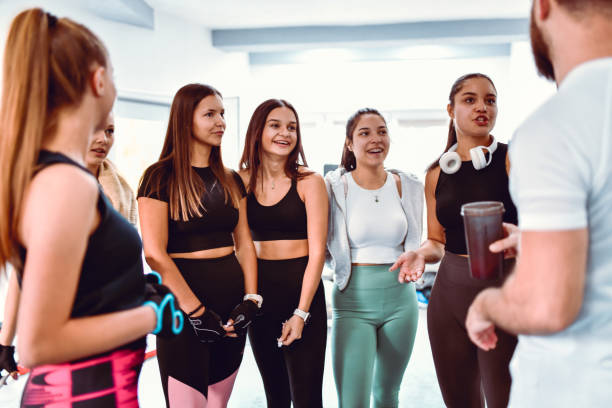 istock Females Talking To Male Fitness Instructor About Program 1426720846