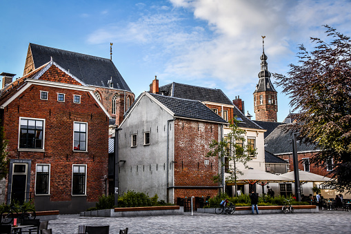 Historic houses and church tower on the riverfront at Deventer, Holland