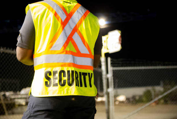 istock Security guard patrolling in fenced commercial area 1426727018