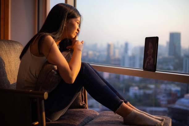 istock lonely woman sitting outside the window 1426742522