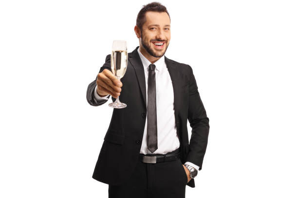 businessman toasting with a glass of champagne and smiling at camera - party business toast champagne imagens e fotografias de stock