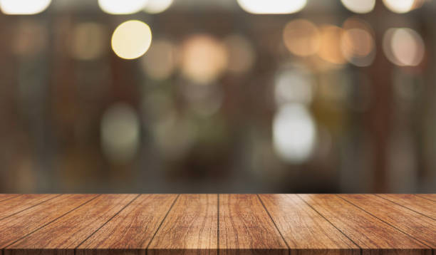 istock Empty wooden table top with lights bokeh on blur restaurant background. 1426765120