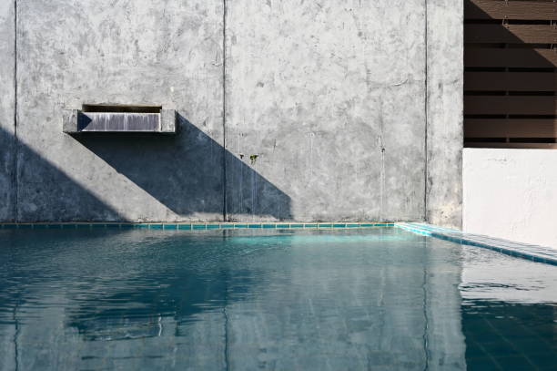 istock faucet of swimming pool on cement wall, construction industry 1426785282