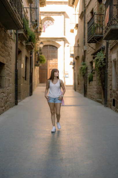 istock woman traveling alone through a medieval village 1426796559