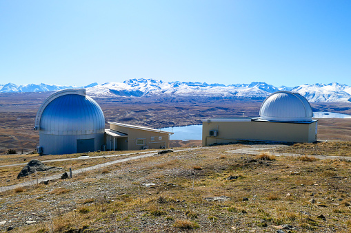 Two of the domes of University of Canterbury Mount John Observatory.  In the background are the Southern Alps and Lake Alexandrina.  This image was taken on a sunny afternoon in early Spring.