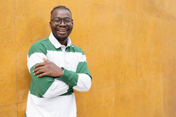 istock Happy young man with  eyeglasses having hands clasped smiling 1426804062
