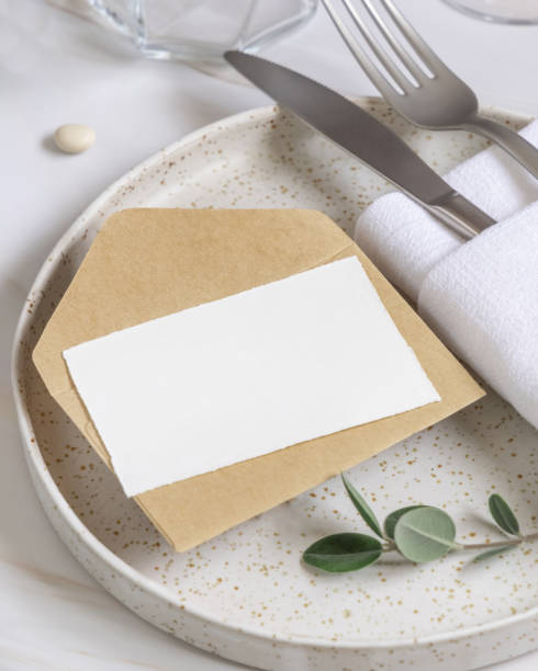 istock Elegant Table setting with a card decorated with eucalyptus branches close up, Wedding mockup 1426805539