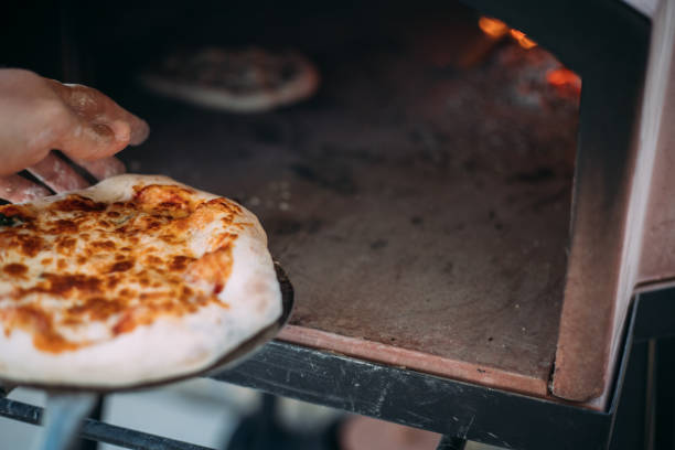 istock Making homemade pizza in portable pizza oven 1426807869