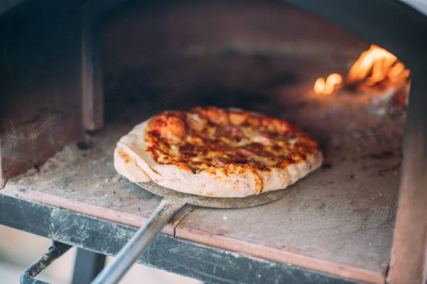 istock Making homemade pizza in portable pizza oven 1426809501