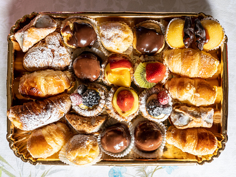 Tray of cream and fruit pastries. Delicious sweets