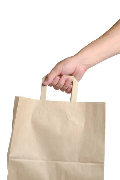 istock Paper shopping bag in hand white background. 1426825193
