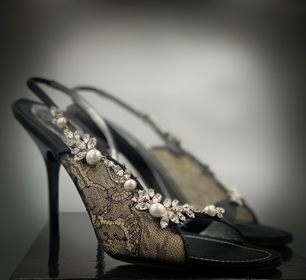 fashion summer shoes for women close up, with beautiful details of pearls, diamonds and lace