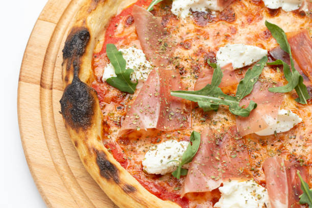 istock Delicious Italian pizza with ham, cheese, arugula and tomatoes. 1426827965
