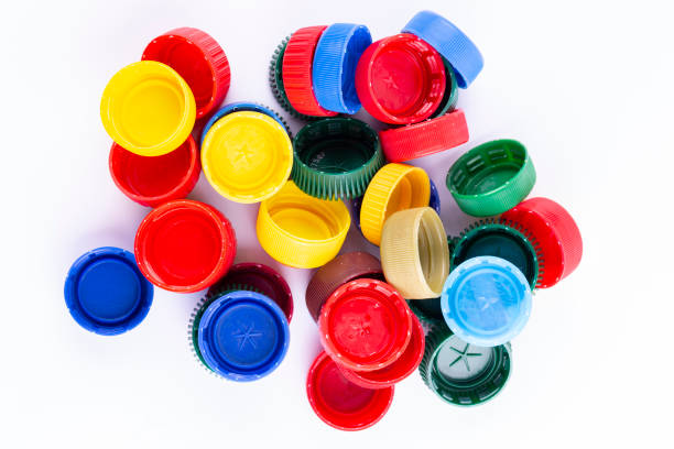 istock Plastic bottle caps on white background. Cap material is recyclable. Recycling collection and processing plastic bottle caps. 1426829285