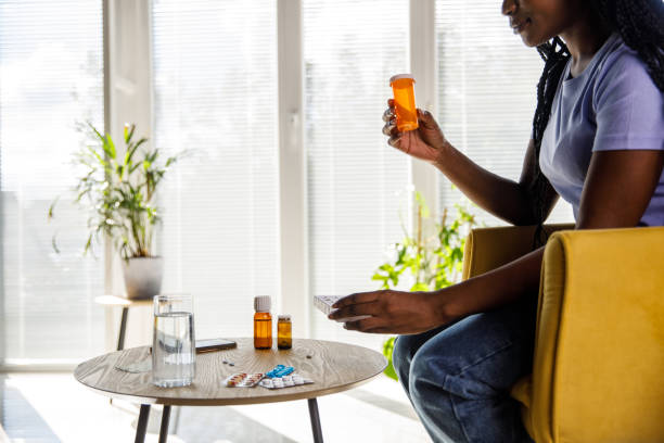 istock Young woman holding a pill box and pill organizing case 1426832206