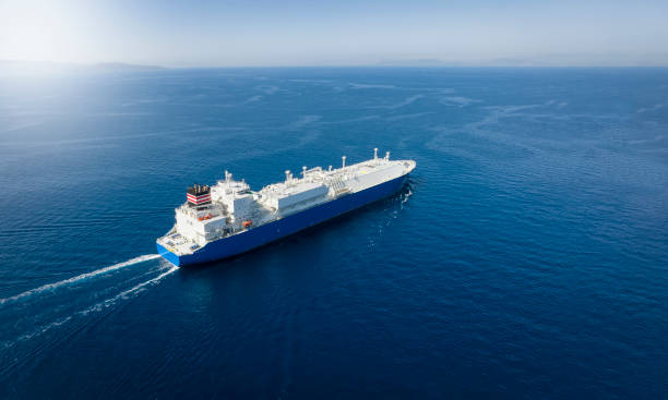 Aerial view of a large LNG or liquid gas tanker ship Aerial view of a large LNG or liquid gas tanker ship traveling over blue ocean, with copy space ship stock pictures, royalty-free photos & images
