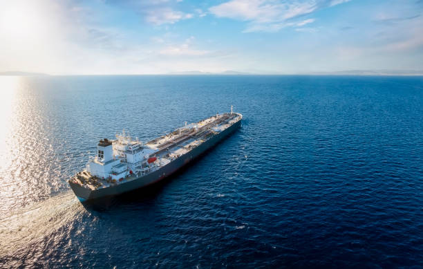 Aerial view of a large, heavy loaded crude oil tanker Aerial view of a large, heavy loaded crude oil tanker traveling over open ocean bulk carrier stock pictures, royalty-free photos & images