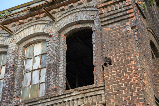 Abandoned old farm building. A sunny day. No people.