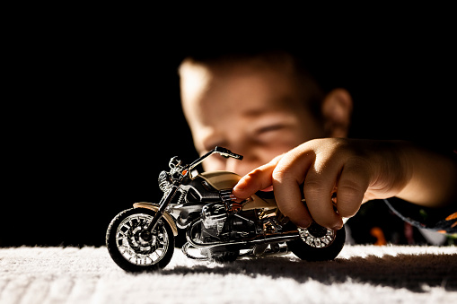 Playing with toy motorcycle