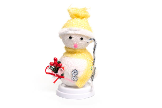 Cute snowman on table against blurred lights