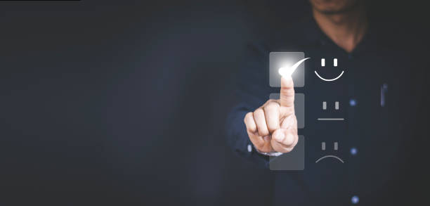 istock Customer Service and Satisfaction Concept Businessman is touching the virtual screen on the happy Smiley face icon to satisfy the service. Rating Very impressed. 1426843962