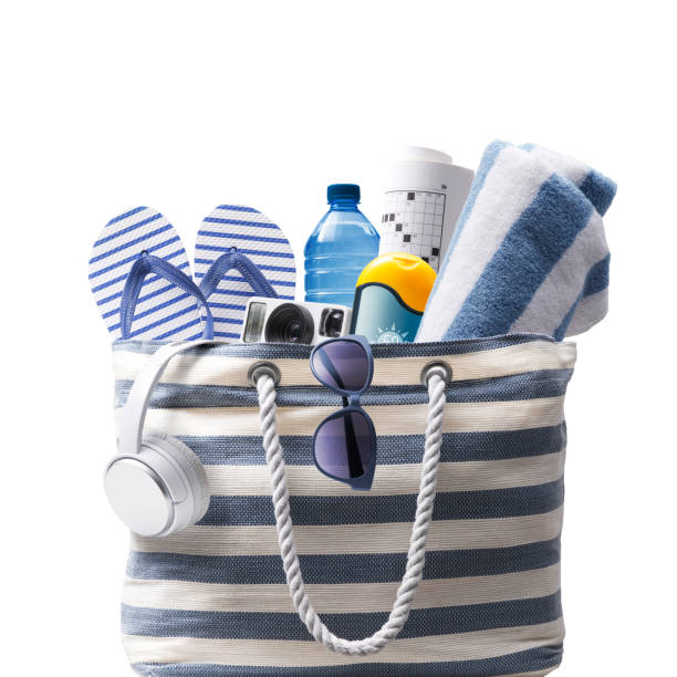 Stylish beach bag with accessories Striped beach bag with accessories, Isolated on white background, summer vacations concept beach bag stock pictures, royalty-free photos & images