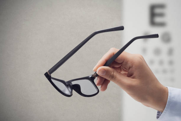 istock Optometrist holding glasses and eye chart 1426846626