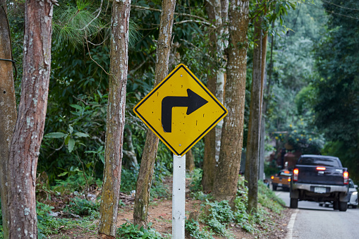 Sharp curve to right sign on asphalt road