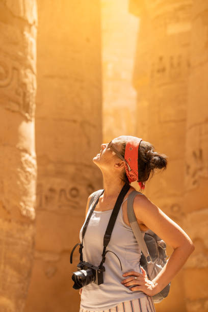 istock Tourist looking up to columns with hieroglyphs in a temple 1426855656