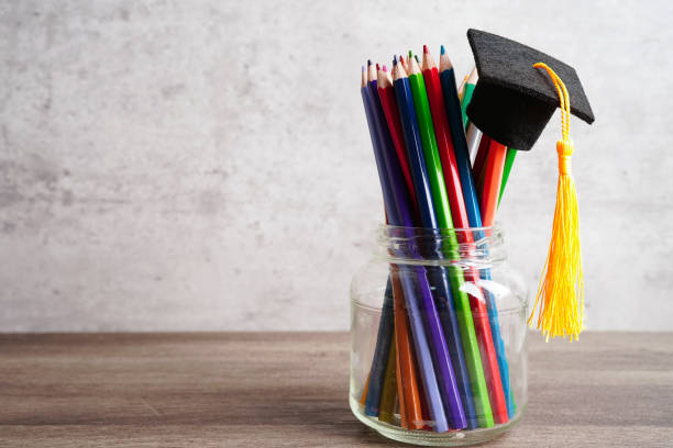 istock Graduation hat with colorful pencils on book with copy space, learning university education concept. 1426856491