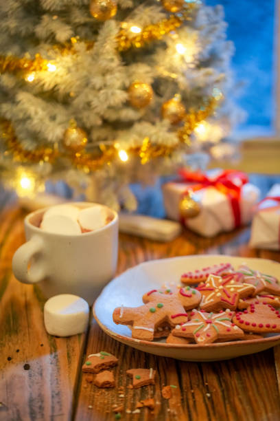 istock Gingerbread cookies and presents under Christmas tree. Background for Christmas. 1426857642