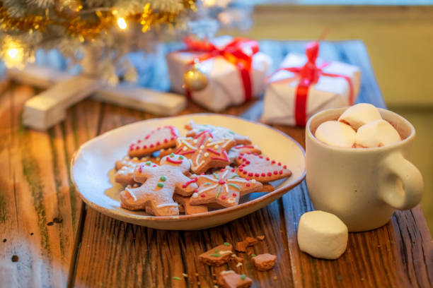 istock Sweet gingerbread cookies under Christmas tree with gifts. 1426857647