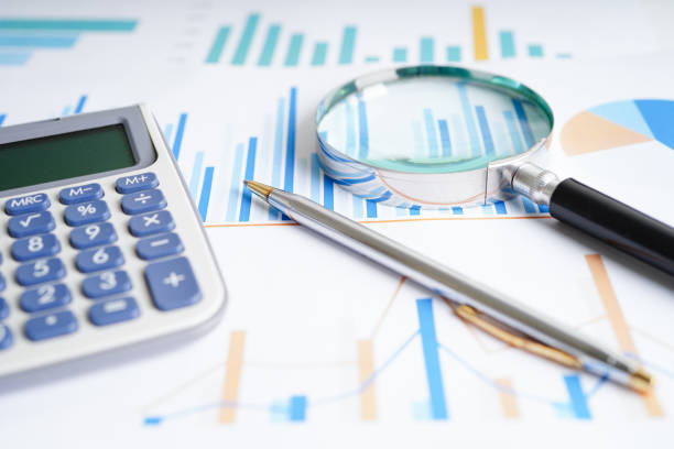 istock Magnifying glass on charts graphs paper. Financial development, Banking Account, Statistics, Investment Analytic research data economy. 1426858737